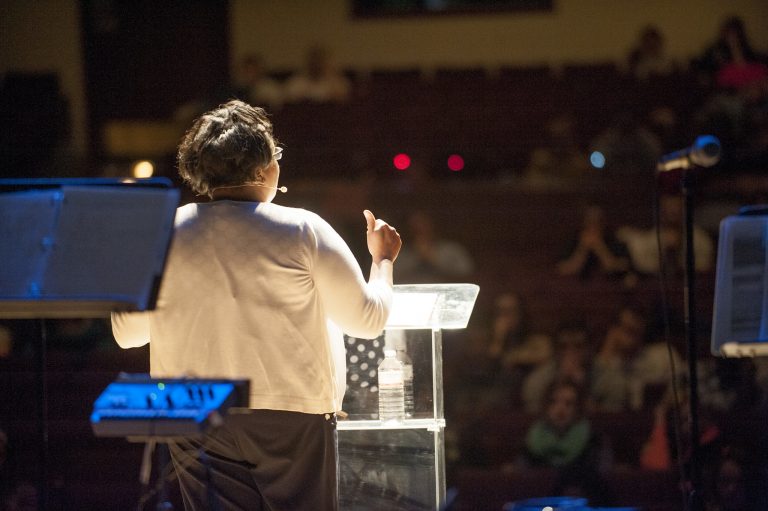 Woman speaking on stage